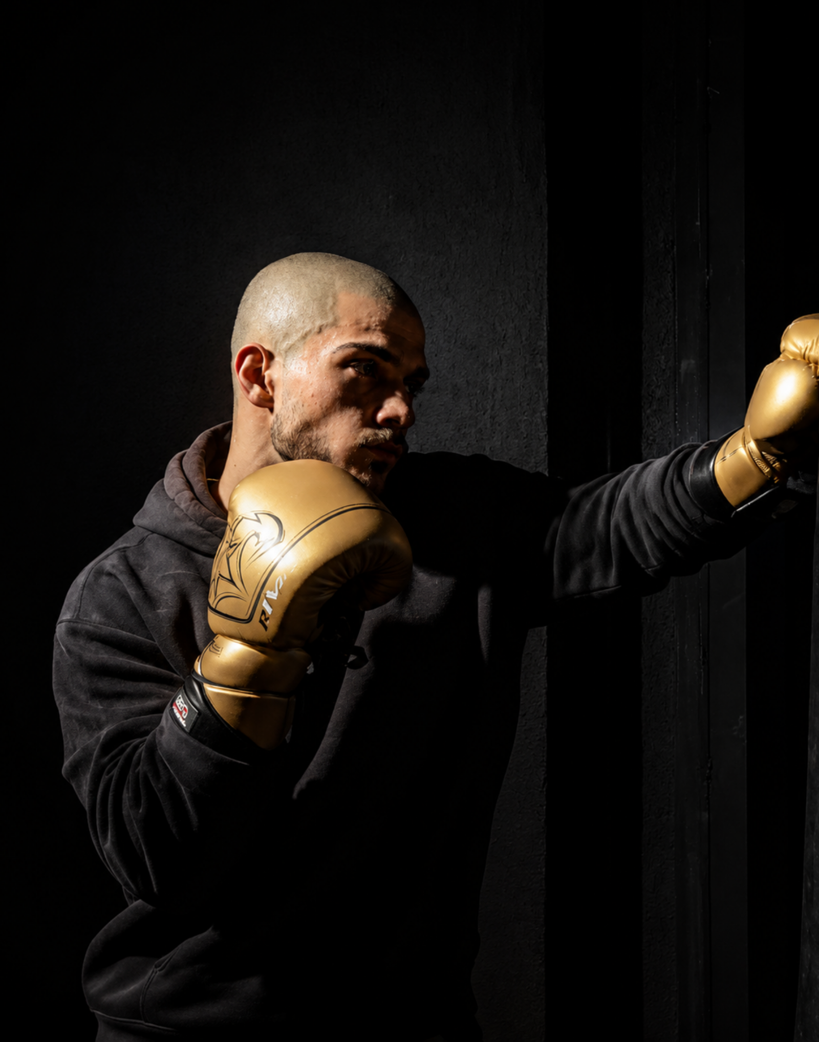 Mustafa Altin training with gold boxing gloves